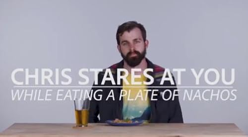 Chris Stares at You While Eating a Plate of Nachos
